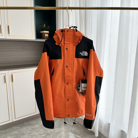 The North Face GORE-TEX Waterproof Hooded Mountain Jacket, Orange and Black Colorblock Outdoor Windbreaker